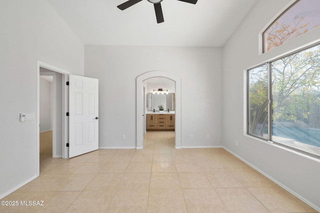 tiled empty room with ceiling fan