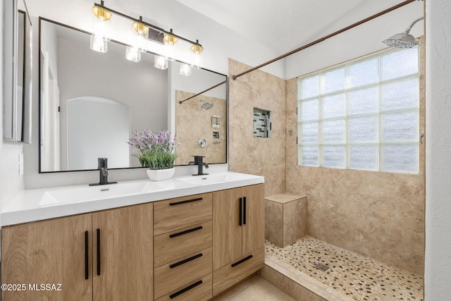 bathroom featuring vanity and a tile shower