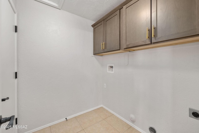 washroom with light tile patterned floors, electric dryer hookup, cabinets, washer hookup, and hookup for a gas dryer