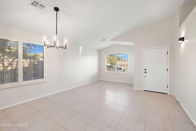 interior space with lofted ceiling, light tile patterned floors, and a chandelier