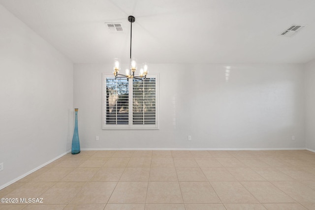 tiled empty room with a chandelier