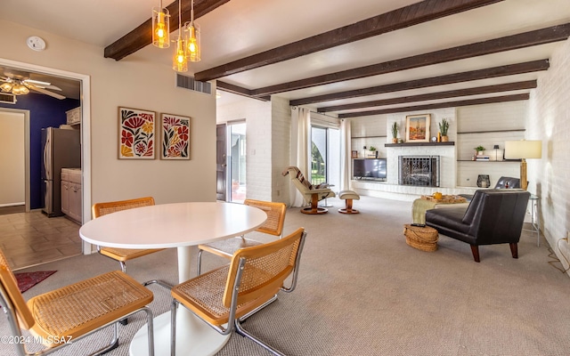 dining area with ceiling fan, beam ceiling, and carpet