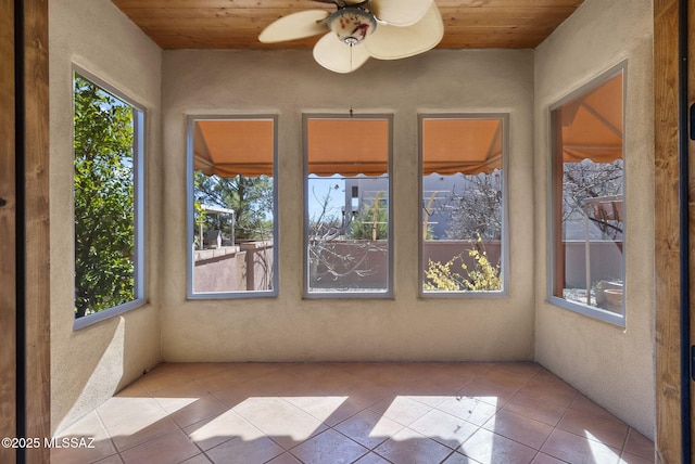 unfurnished sunroom with wooden ceiling and ceiling fan