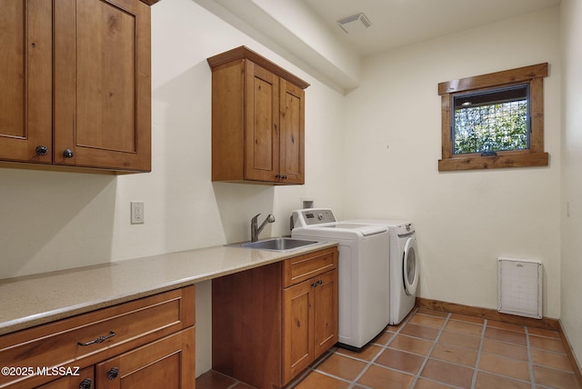 washroom featuring cabinets, washing machine and dryer, sink, and tile patterned flooring