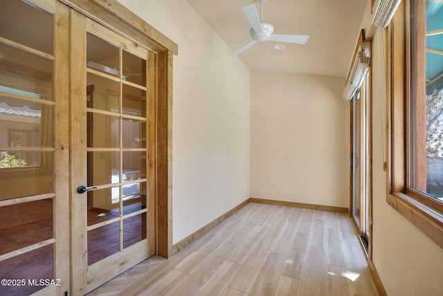 spare room featuring french doors, ceiling fan, and light hardwood / wood-style floors