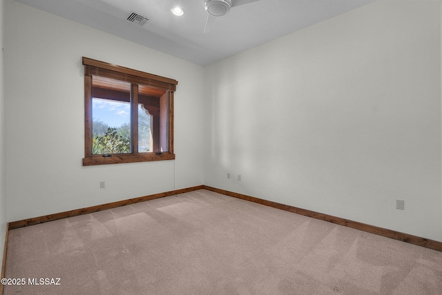 empty room with light colored carpet and ceiling fan