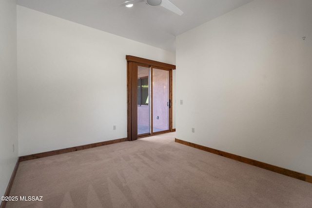 carpeted spare room with ceiling fan