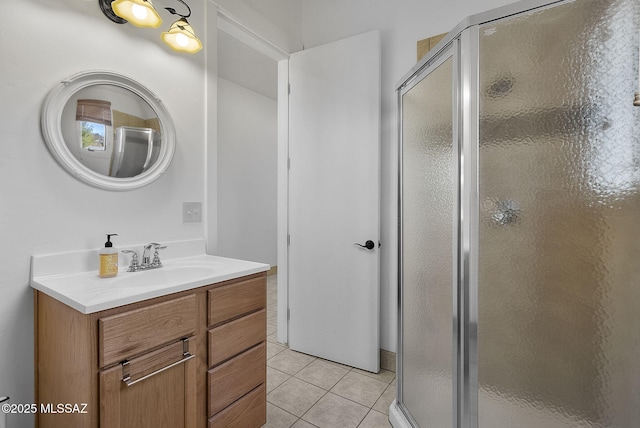 bathroom featuring tile patterned flooring, vanity, and walk in shower