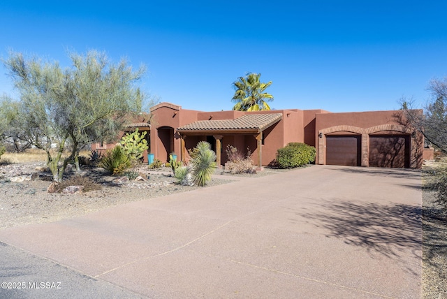 adobe home featuring a garage