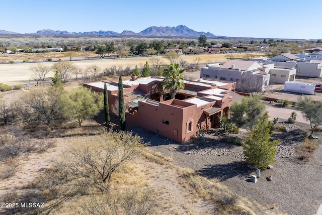 birds eye view of property featuring a mountain view