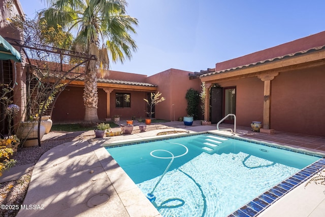 view of pool with a patio area and a fire pit