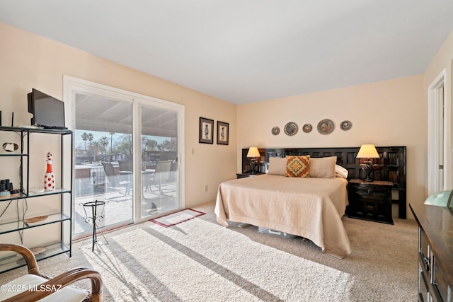 bedroom with light colored carpet and access to exterior