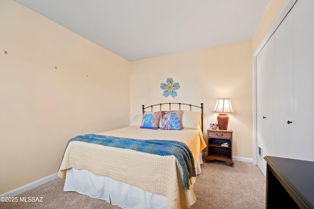 bedroom with light colored carpet and a closet