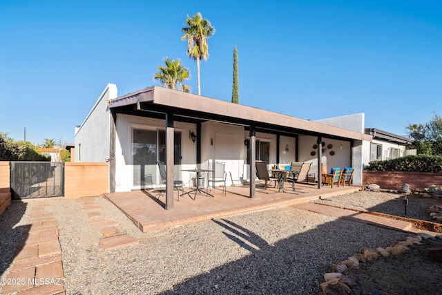 rear view of property featuring a patio area