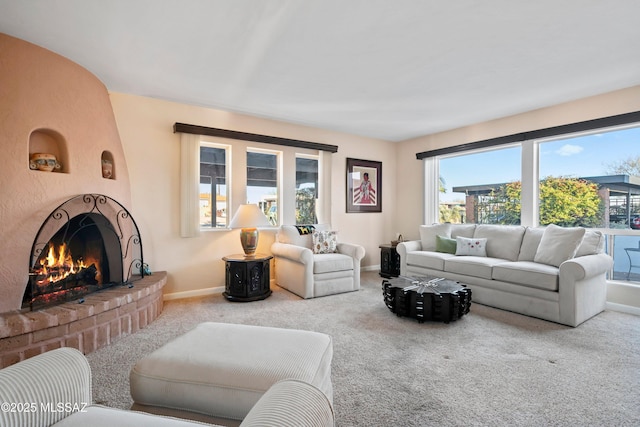 living room with a fireplace and carpet flooring