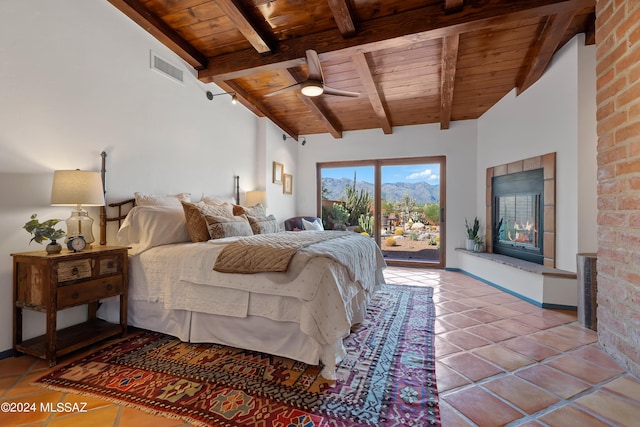 tiled bedroom featuring lofted ceiling with beams, access to exterior, wooden ceiling, and ceiling fan