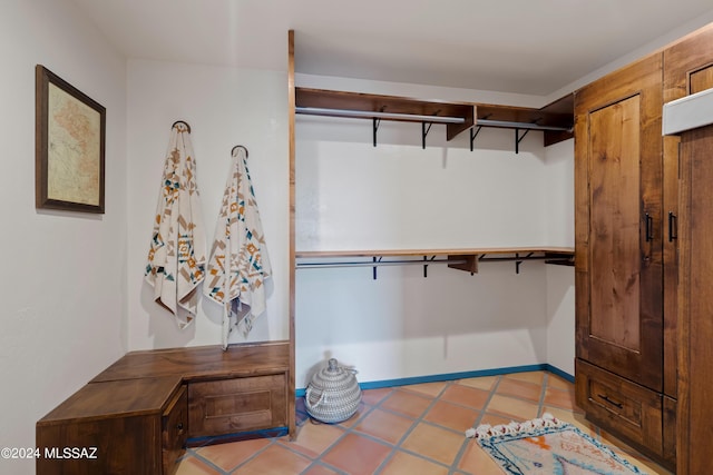 spacious closet with light tile patterned floors