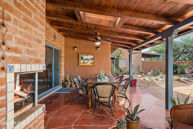 view of patio with a multi sided fireplace and ceiling fan