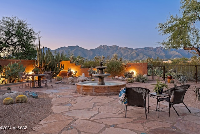 patio terrace at dusk with a mountain view