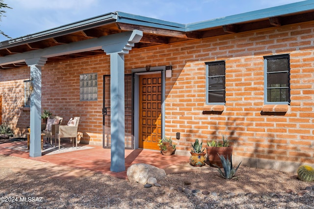 doorway to property featuring a patio area