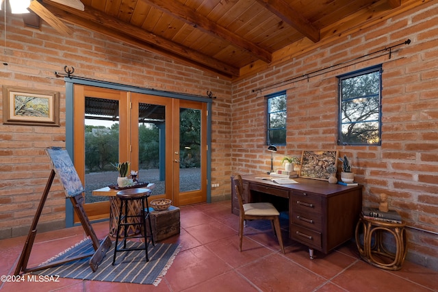 tiled home office with wood ceiling, french doors, beamed ceiling, and brick wall