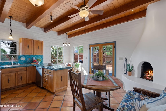 kitchen featuring sink, wood ceiling, hanging light fixtures, stainless steel dishwasher, and a fireplace