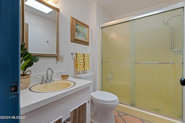 bathroom featuring walk in shower, vanity, and toilet