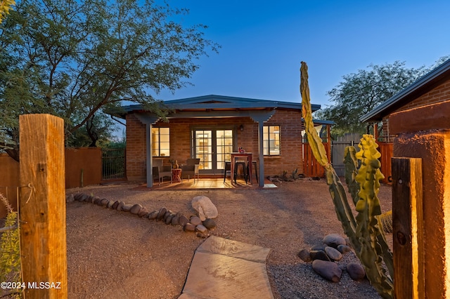 rear view of house featuring french doors