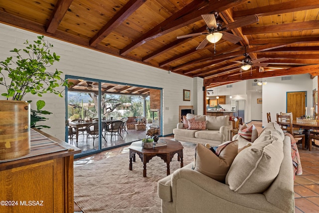 living room featuring vaulted ceiling with beams, wood ceiling, ceiling fan, and light tile patterned flooring