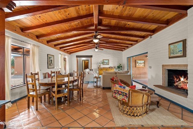 tiled dining area featuring vaulted ceiling with beams, wood ceiling, and brick wall