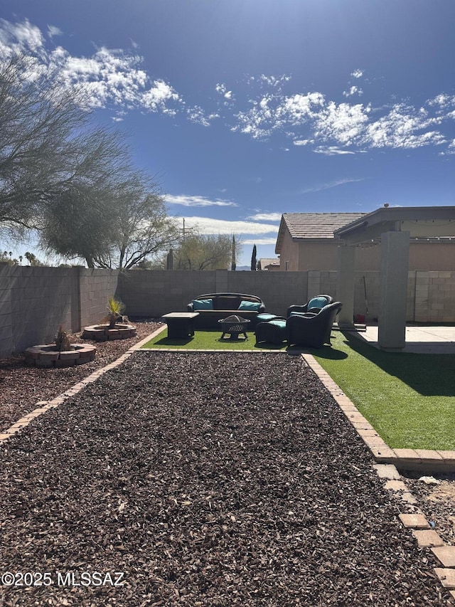 view of yard with an outdoor living space and a patio area