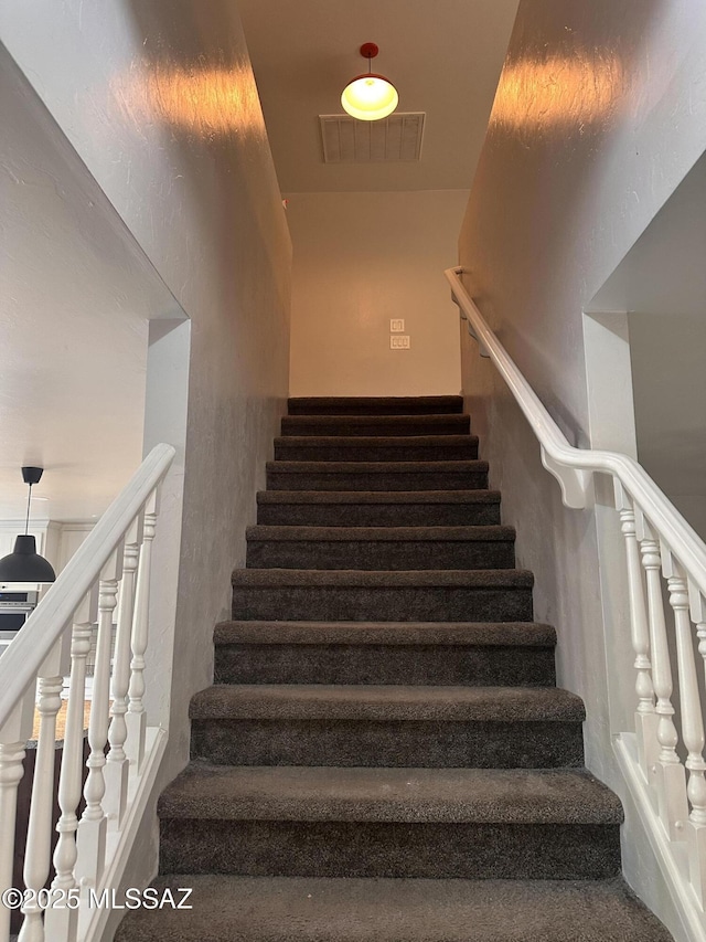 staircase featuring visible vents
