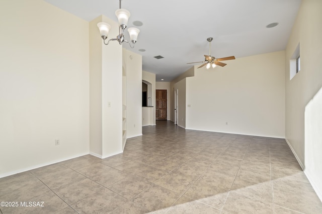 tiled spare room featuring ceiling fan with notable chandelier