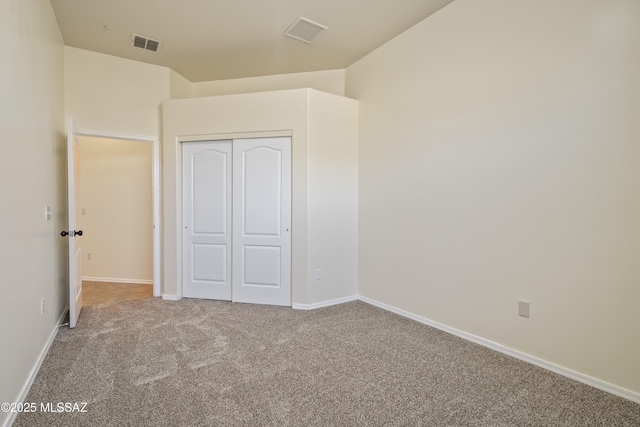 unfurnished bedroom with a closet and carpet