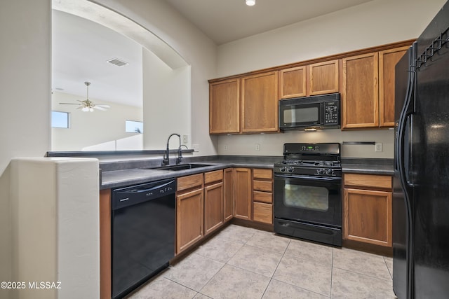 kitchen featuring light tile patterned flooring, ceiling fan, sink, and black appliances