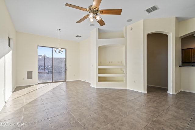 interior space featuring ceiling fan with notable chandelier, tile patterned flooring, and built in features