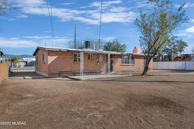 rear view of house with cooling unit and a patio