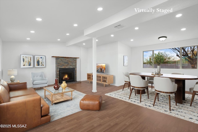 living room with a fireplace, lofted ceiling, and dark hardwood / wood-style floors