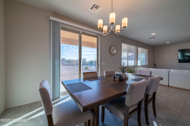 dining area with a wealth of natural light and a chandelier