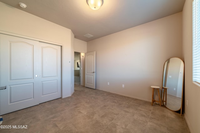 unfurnished bedroom with a closet