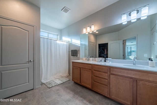 bathroom featuring tile patterned flooring and vanity