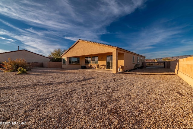 rear view of house with a patio