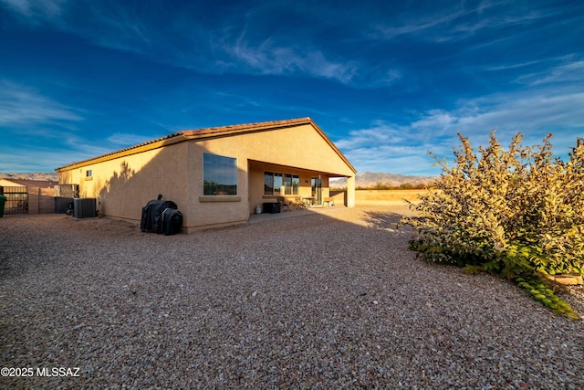 rear view of property featuring a patio and central air condition unit