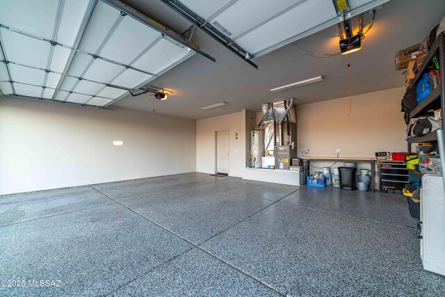 garage with a garage door opener and water heater