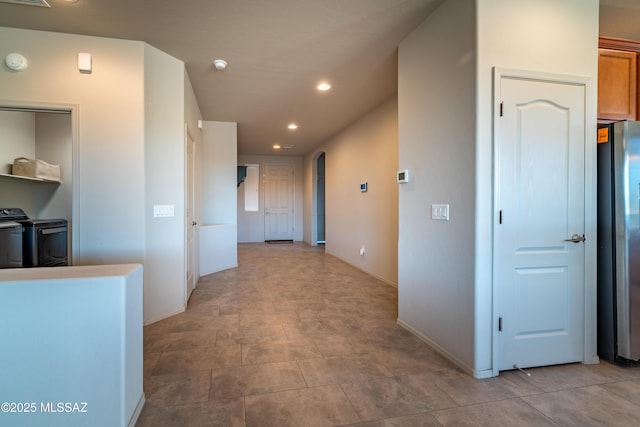 hallway featuring washing machine and clothes dryer