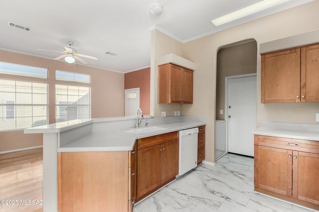 kitchen featuring sink, ceiling fan, white dishwasher, ornamental molding, and kitchen peninsula