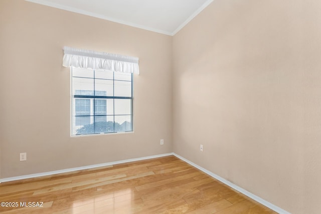 spare room featuring crown molding and light hardwood / wood-style flooring