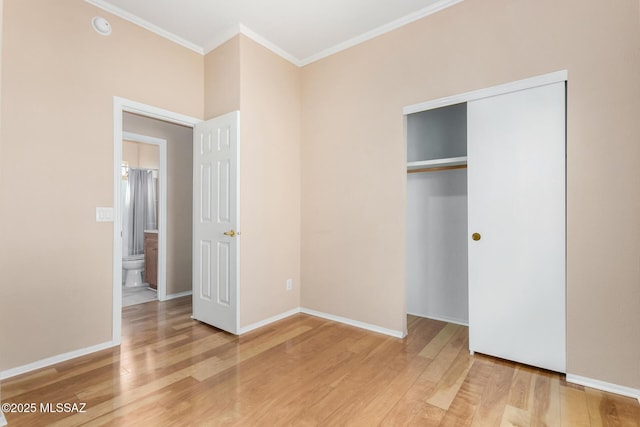 unfurnished bedroom featuring crown molding, hardwood / wood-style flooring, and a closet