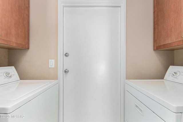 laundry room with cabinets and separate washer and dryer