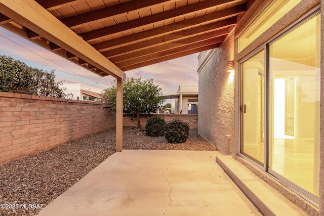 view of patio terrace at dusk